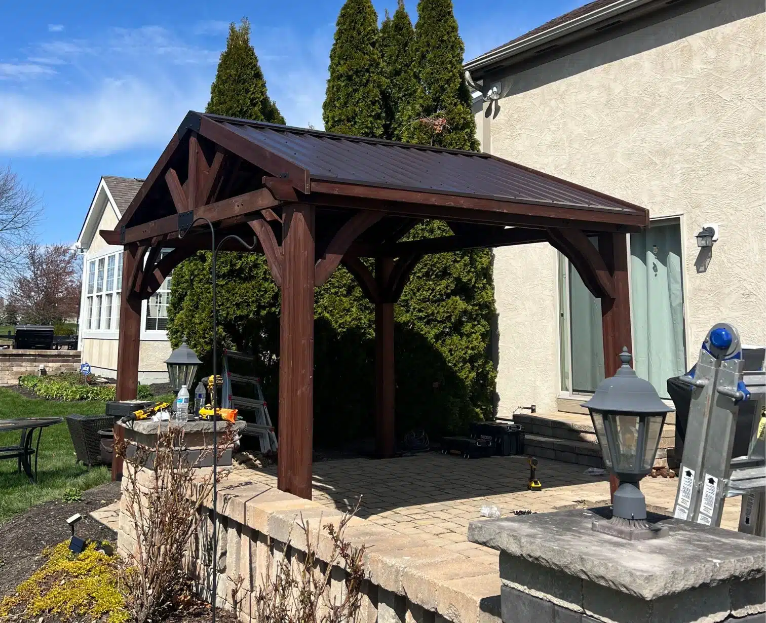Custom wood gazebo installed over backyard patio for outdoor living space
