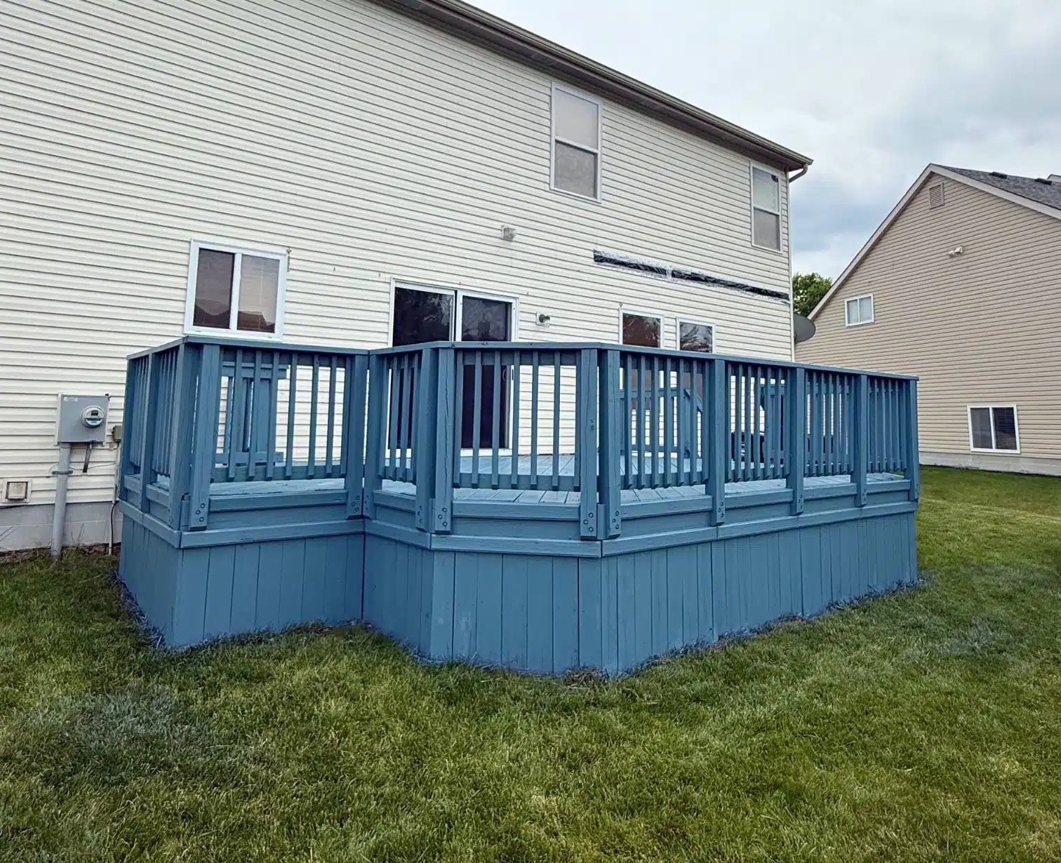 Exterior deck painting with blue finish and railing detail