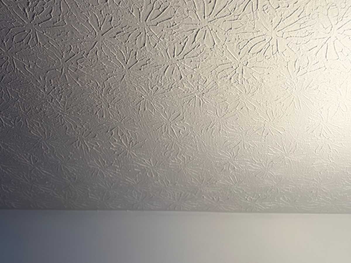 After - textured ceiling with a large cutout exposing the damaged area for drywall ceiling repair work