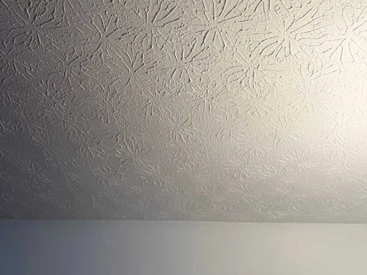 After - textured ceiling with a large cutout exposing the damaged area for drywall ceiling repair work