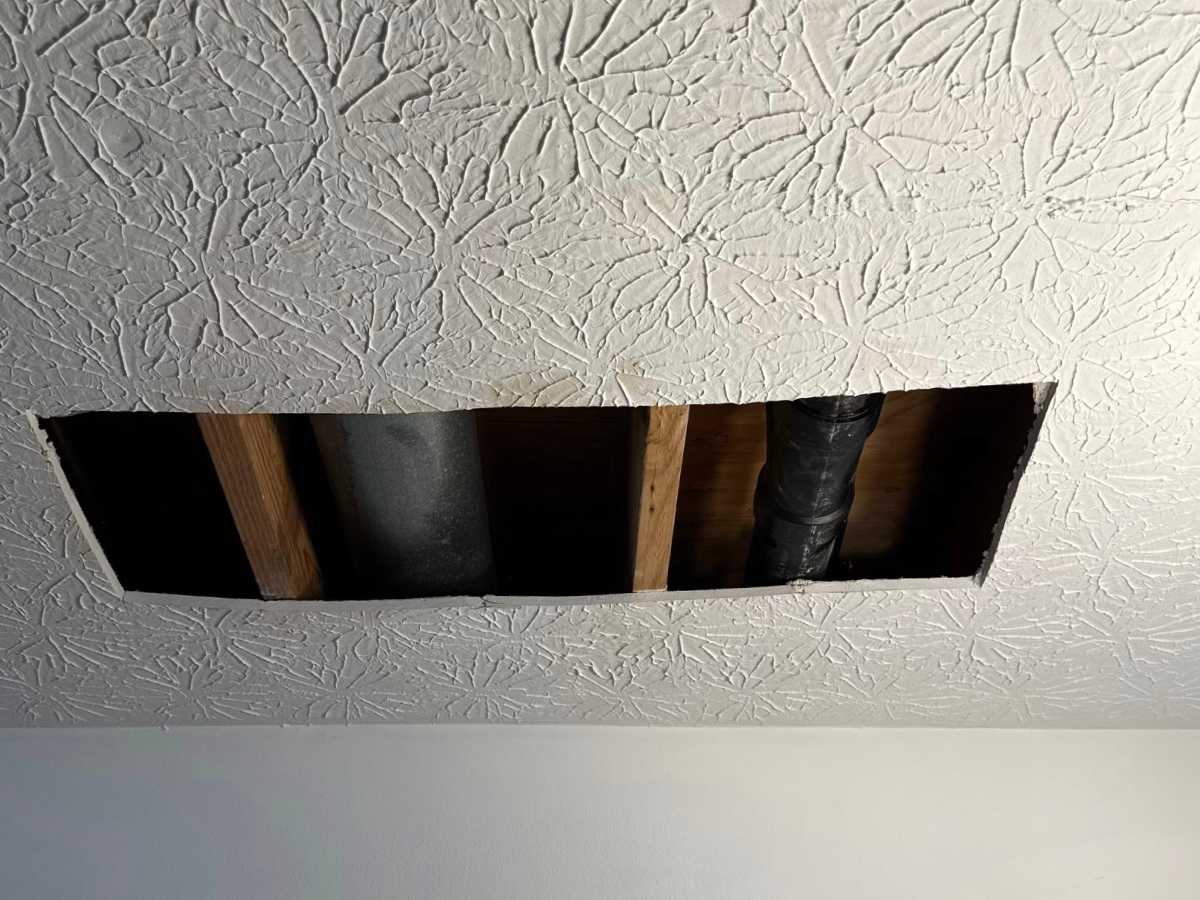 Before - textured ceiling with a clean finished surface before drywall ceiling repair begins