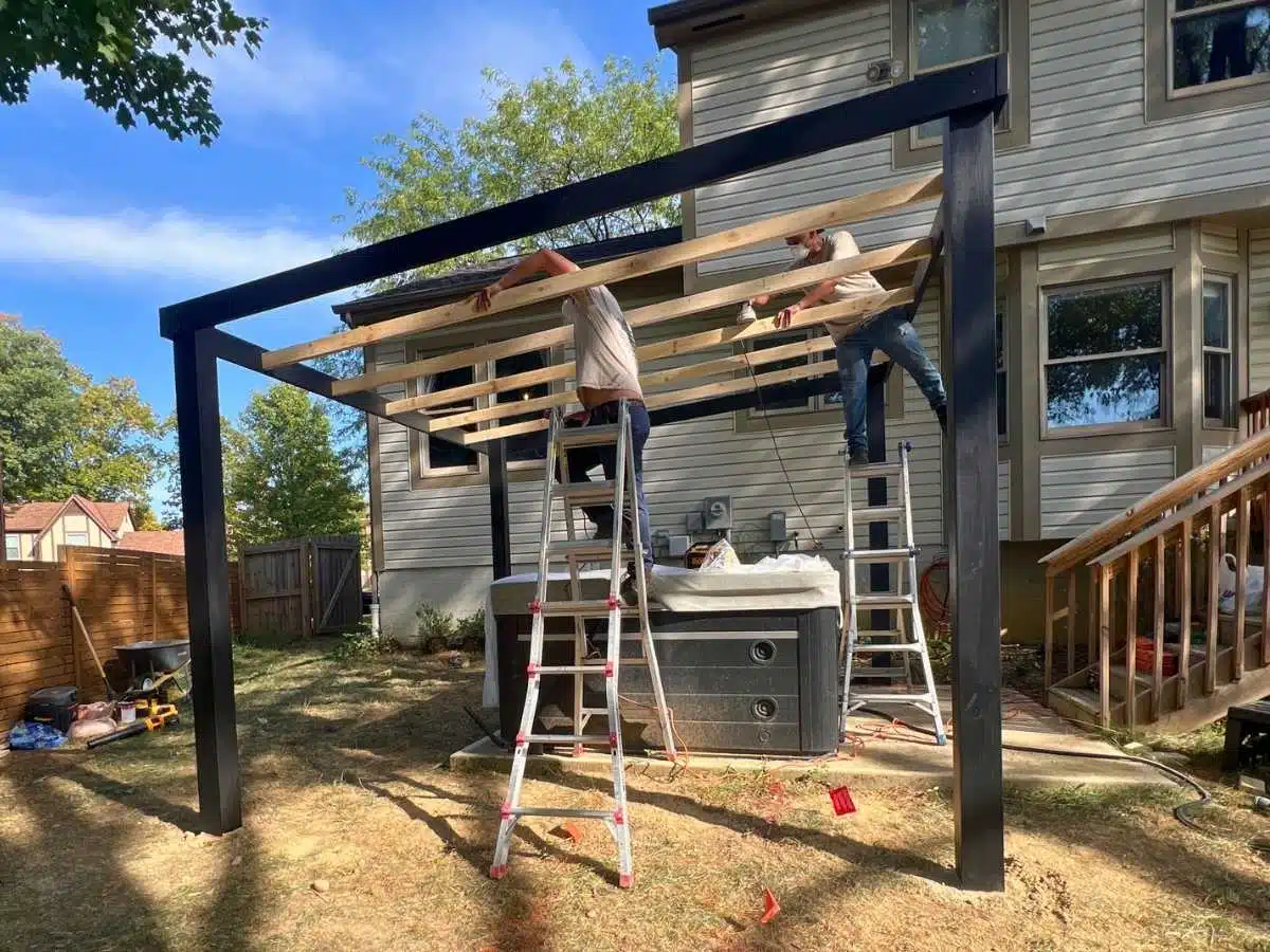 Custom gazebo restoration in progress with framed structure being assembled over a backyard hot tub