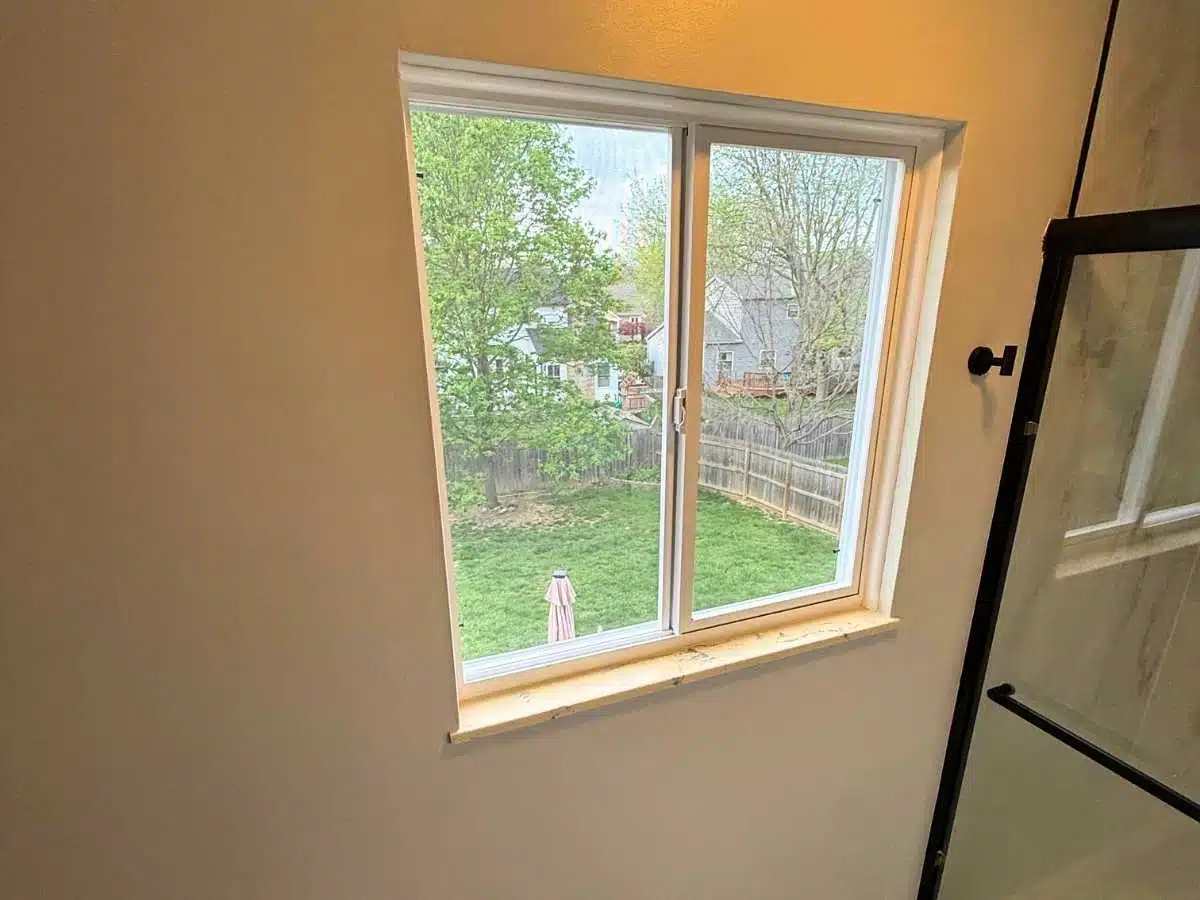 finished bathroom window area with fresh drywall work clean trim and smooth painted walls