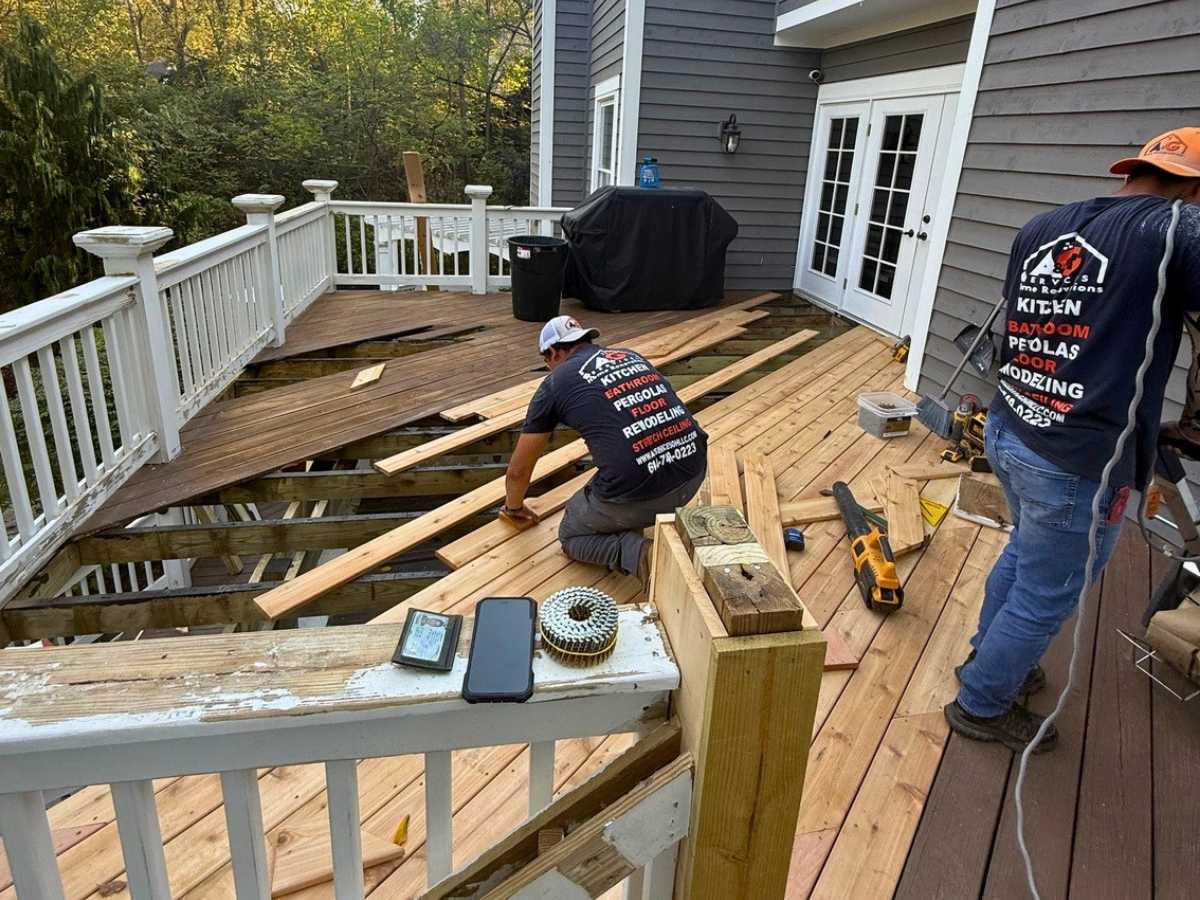 A&G Services crew replacing damaged wood boards during a deck renovation